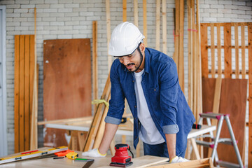 Carpenter working in carpentry shop. Carpenter working to making wood furniture in wood workshop