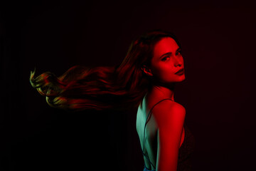 Photo of charming lovely young girl celebrity posing isolated on dark red neon color background