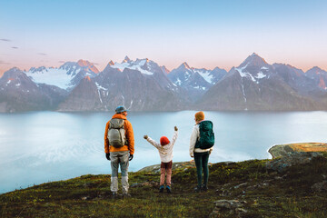 Family mother, father, and kid hiking together in Norway, travel lifestyle adventure vacations in Lyngen Alps mountains, parents and child on active outdoor backpacking trip healthy lifestyle tour