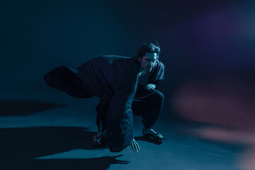 Fototapeta premium A guy in a kimono and geta in the image of a charismatic villain, dynamic poses, wide-angle view