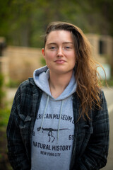 portrait of a girl, young woman, wearing plaid and fall, winter clothes outdoors.