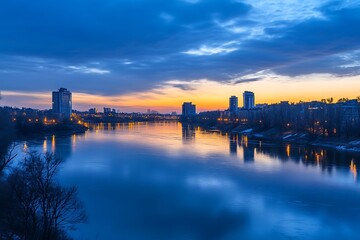 City skyline at dusk with reflection in river water