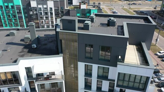 Modern architecture - infrastructure on the roof of a modern high-rise residential building. Air vents, pipes, ventilation shafts, lightning rods, drainage systems, generators, air conditioners