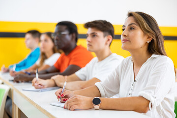Woman with other adult students in studying with their colleagues