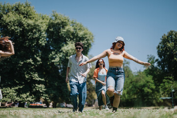Group of friends enjoying a sunny day in the park. They are running and having fun together outdoors, showcasing happiness and friendship.