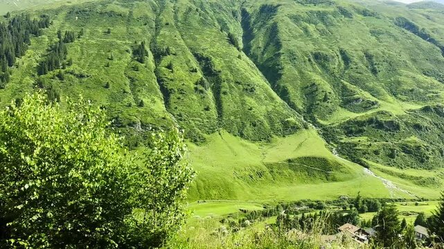 Panoramic View over Golf Course in Mountain Valley From Train Glacier Express in a Sunny Summer Day in Sedrun, Surselva, Oberalp, Grisons, Switzerland, Europe