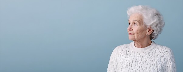 Senior woman isolated on gray background. Studio portrait. Dementia and Alzheimer's disease concept. Memory loss awareness. Banner with copy space