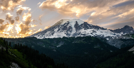 Golden Clouds Fill The Sky Over Snow Covered Mount Rainier