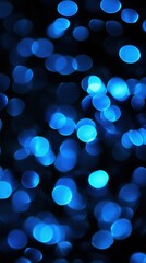 Abstract defocused blue light bokeh on a dark background, creating a serene and magical atmosphere.