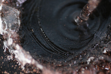 Macro shot of residue or particles out from the tap water