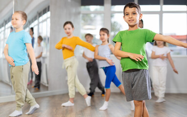 Group of children boys and girls dance contemporary dance in studio