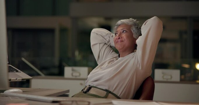 Business, woman and relax at night in office with computer for stress relief and evening debrief of project completion. Mature, web and graphic designer for company with smile for website layout.
