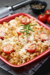 Delicious al forno pasta in baking dish on grey table, closeup