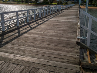 Obraz premium View Along Rustic Wooden Decked Pier