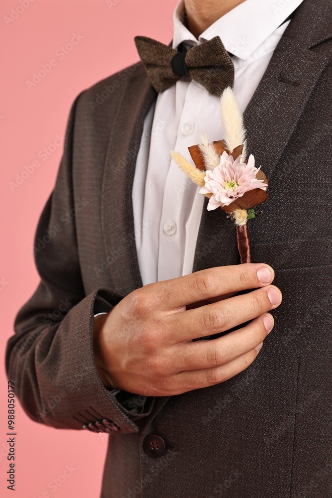 Canvas Prints Groom in suit with stylish boutonniere on pink background, closeup