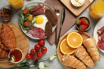 Different tasty food served for brunch on grey marble table, flat lay