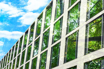 Fototapeta premium Environment preservation. Double exposure of modern building and trees, low angle view