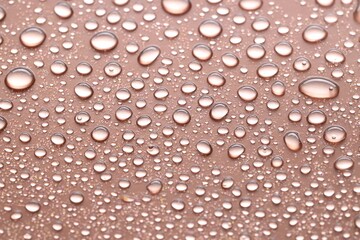 Water drops on brown background, closeup view