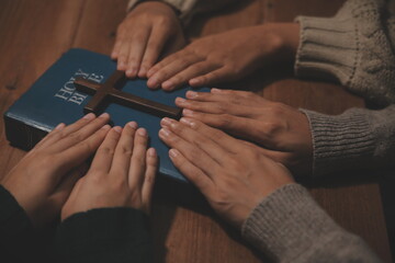 Christian group are praying to god with the bible and sharing the gospel. Concept of faith for god.