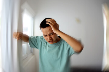 Young Asian Man Feels Dizzy While Walking at Home With Feeling Pain and Spinning Sensation in His...