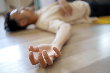 Close Up of Person Hands Who has a Seizures Disorder Lying on The Floor