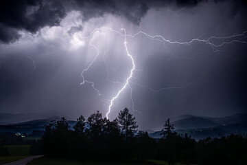 lighting at a heavy thunderstorm in the bavarian alps near Siegsdorf, Chiemgau, Bavaria, Germany