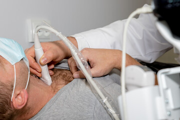 Ultrasound scanning diagnostic of woman thyroid gland in clinic, doctor runs ultrasound sensor.patient receives thyroid diagnostics. Treatment of thyrotoxicosis, and hypothyroidism. endocrine system