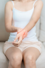 Woman having wrist pain at home, muscle ache due to De Quervain s tenosynovitis, ergonomic, Carpal Tunnel Syndrome or Office syndrome and Parkinson disease concept