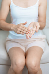 Skin care lotion and Skin body cream Moisturizing, Sunscreen and Healthy Daily Routine concepts. Beauty Woman applying moisturizing skincare cream on hand and body at home