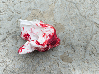 Crumpled bloody tissue paper on the ground concept murder, crime, accident, incident, emergency © JOWO PARALON AS