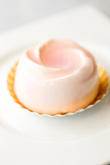 Rose white chocolate mousse cake serve on white plate