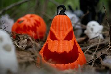 3D printed halloween pumpkins with spider webs and ghost decorations on dried leaves