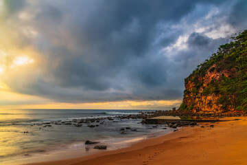 Cloud covered sunrise at the seaside