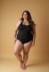 Obraz premium Curvy Beauty: Plus-Size Model in Black Swimsuit Posing on the Floor 