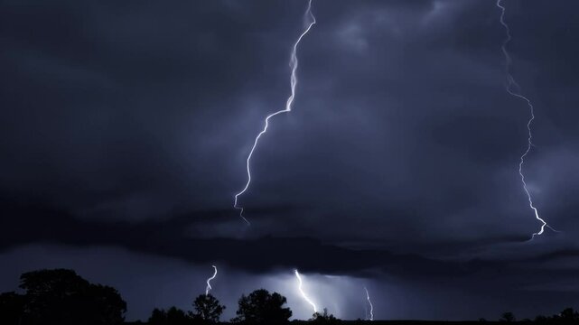 Thunderstorm flashes with multiple bolts of lightning on dark cloudy sky