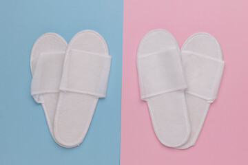 Pair of White Slippers on Dual-Tone Background - Pastel Blue and Pink