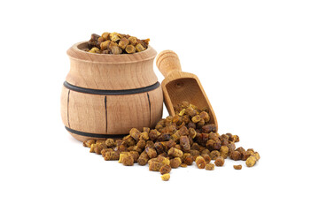 Bee bread in a rustic wooden barrel with a small wooden scoop on white background