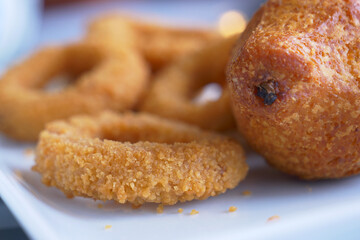 A scrumptious plate filled with delicious golden fried snacks that look incredibly appetizing