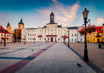Stunning morning cityscape of Plock town, Masovian Voivodeship. Amazing summer sunrise on Market Square with Town Hall on background, Poland, Europe. Travel the world..