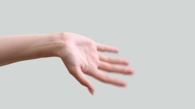 Vertical video. Hi gesture. Hello greeting. Friendly welcome. Meeting acquaintance. Female hand waving hey isolated on light neutral copy space background.