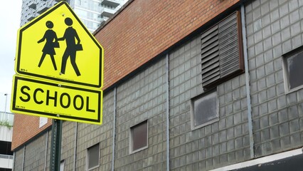 School zone yellow road sign, pedestrian crossing. Children safety on street, New York City. Transport and education symbol, USA . Traffic roadsign in Queens, Long Island, Hunters point.