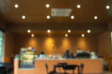 Abstract blur interior coffee shop restaurant or cafe and kitchen for background, counter top on of clean abstract home indoor. Warm tone used for display or montage your food dining banner products.