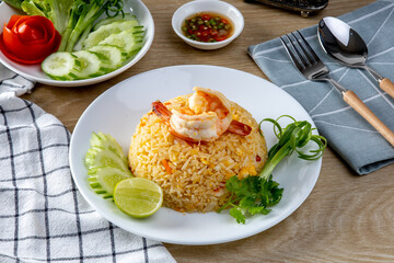 Shrimp fried ricei put in a white plate on the wooden table