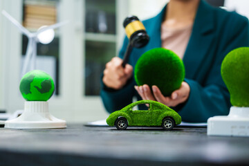 An Asian businesswoman  her desk discusses environmental laws, clean energy,wind turbines,sustainable home solutions.She emphasizes green initiatives,waste management eco-friendly cars,  preserving