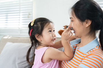 Mother and Daughter Bonding Time at Home with Playful Interaction and Smiles