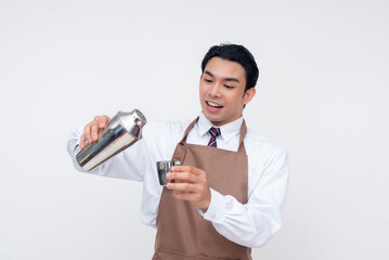 An Asian bartender skillfully pours a mixed drink from a shaker into a shot glass, showcasing...