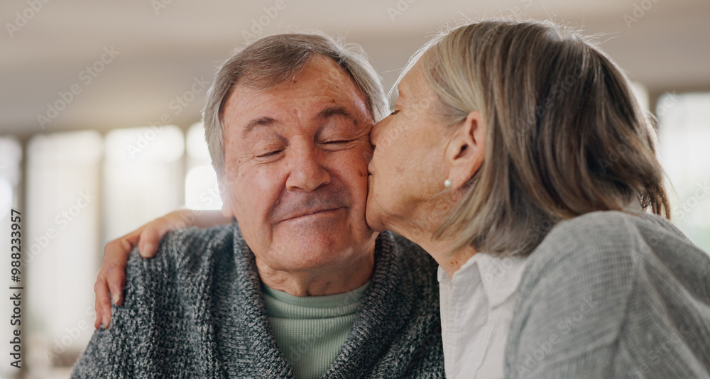 Wall mural Senior woman, man and kiss cheek in home with smile, hug and eyes closed with bonding in retirement. Couple, embrace and happy with love with memory, connection and relax together in morning at house