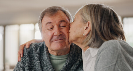 Senior woman, man and kiss cheek in home with smile, hug and eyes closed with bonding in retirement. Couple, embrace and happy with love with memory, connection and relax together in morning at house