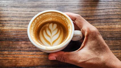 Top view latte art coffee on wood background