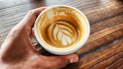 Top view latte art coffee on wood background